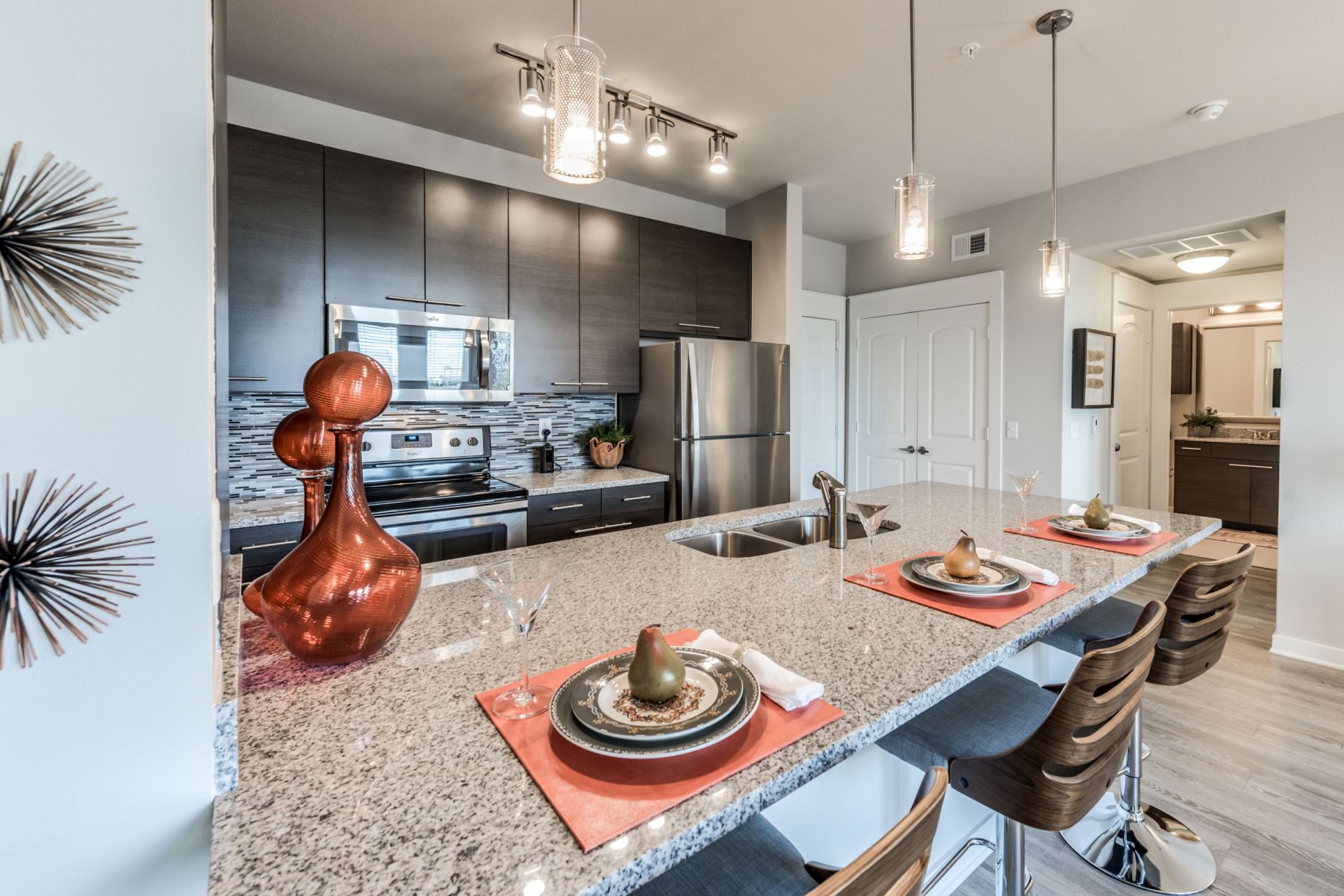 Luxury apartment kitchen with stainless steel appliances, granite countertops, and lots of storage space